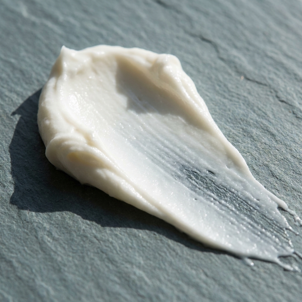 Botanical skin cream texture swatched on natural slate